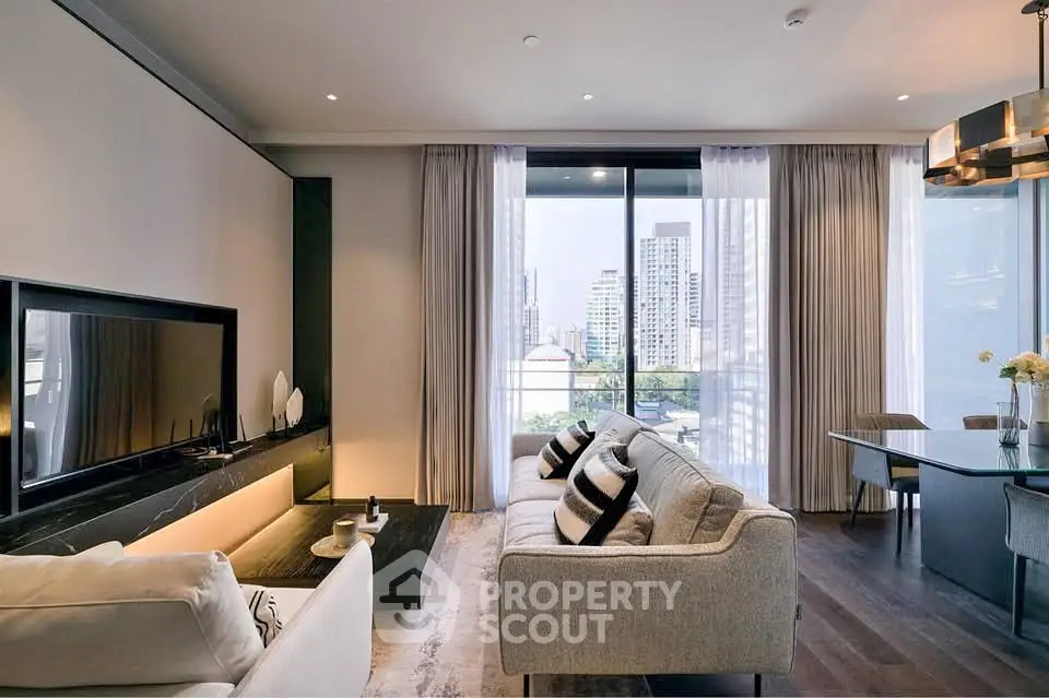 Luxurious modern living room with large windows and city view, featuring elegant furniture and stylish decor.