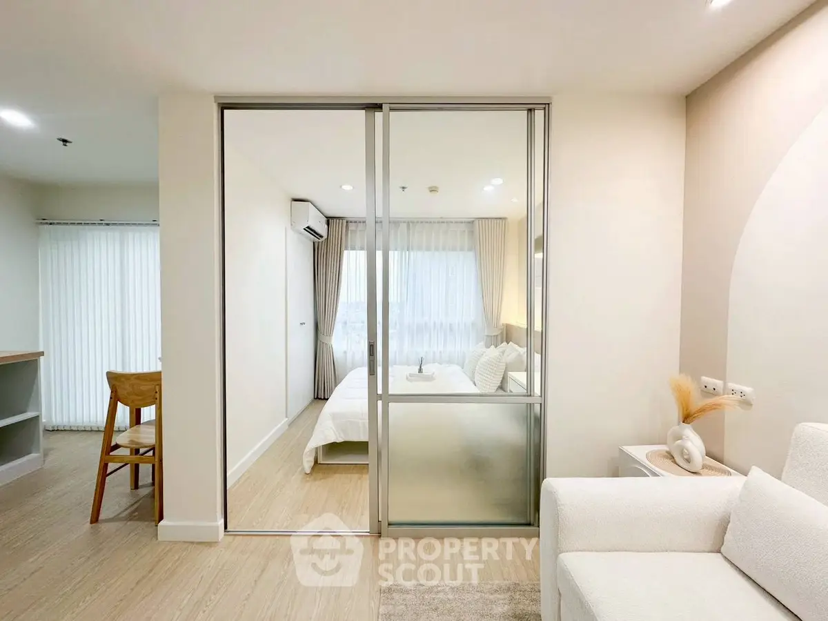 Modern apartment interior with sliding glass doors and cozy bedroom