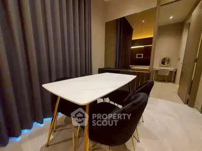 Modern dining area with elegant table and chairs, featuring ambient lighting and stylish decor.
