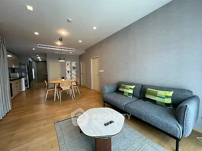 Spacious modern living room with stylish furniture and open kitchen layout