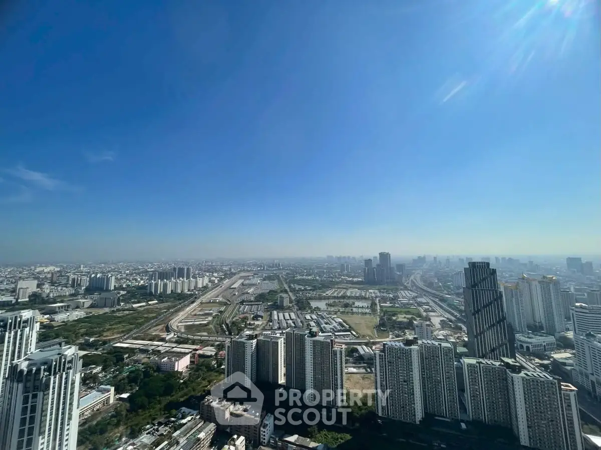 Stunning cityscape view from high-rise building showcasing urban skyline and clear blue sky.