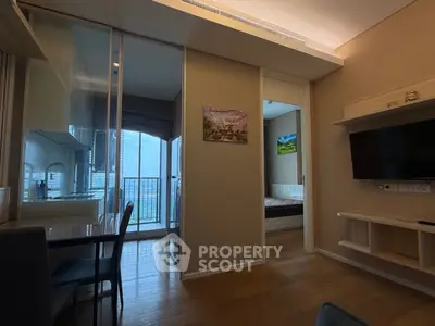 Modern apartment interior with glass partition, cozy bedroom, and balcony view.