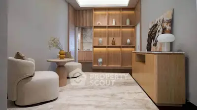 Elegant modern living room with stylish furniture and built-in wooden shelves, perfect for sophisticated living.