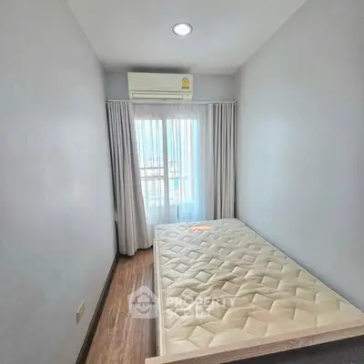 Cozy bedroom with natural light and air conditioning, perfect for a comfortable living experience.