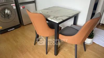 Modern kitchen corner with marble table and stylish chairs