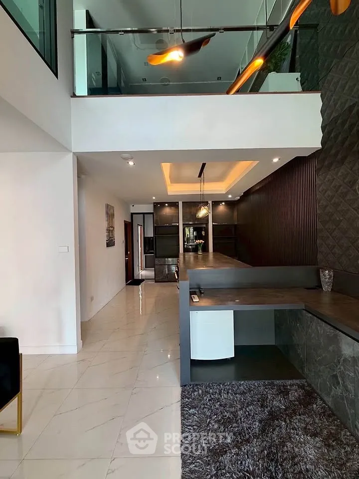 Modern duplex interior with sleek design and open layout, featuring stylish lighting and contemporary finishes.