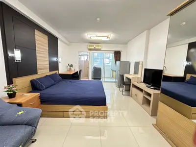 Spacious modern bedroom with balcony access and sleek furnishings