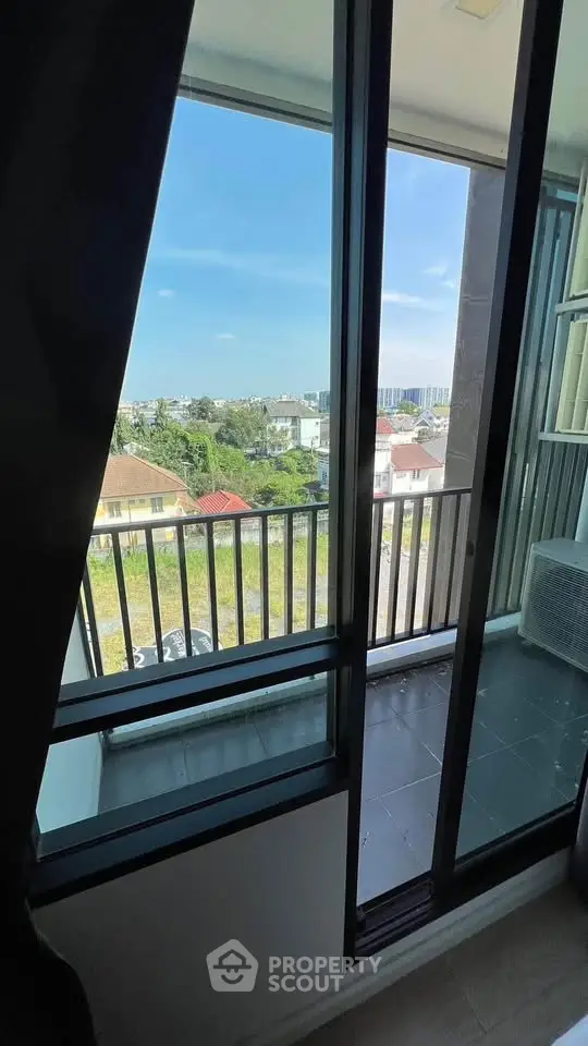 Charming balcony view with cityscape and lush greenery, perfect for relaxation.