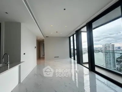 Luxurious corner unit with stunning city and river views, featuring sleek marble flooring and expansive windows.