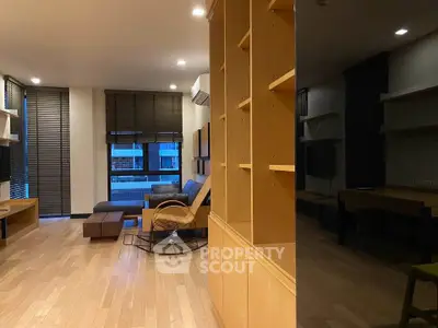 Spacious modern living room with wooden flooring and stylish furniture