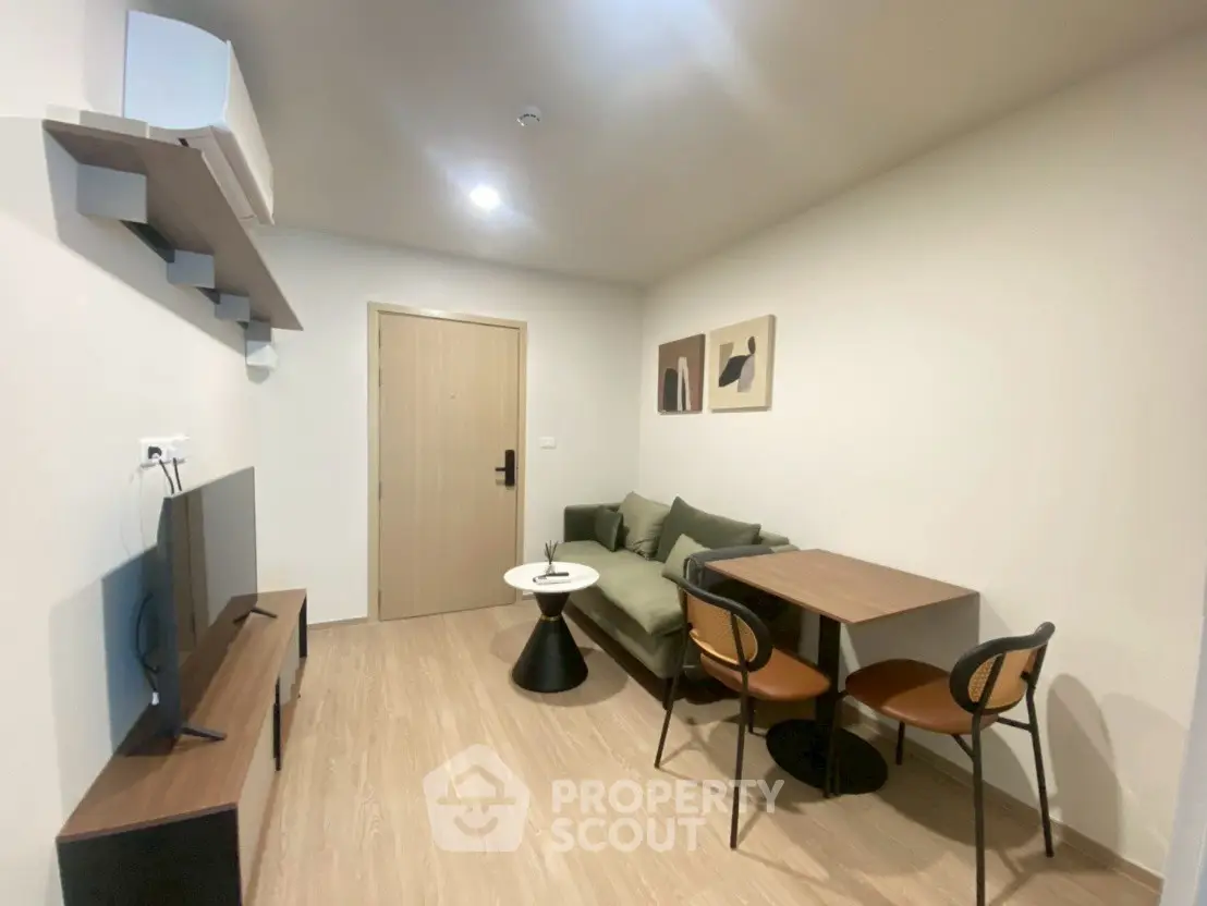 Modern living room with cozy sofa and dining area in stylish apartment.