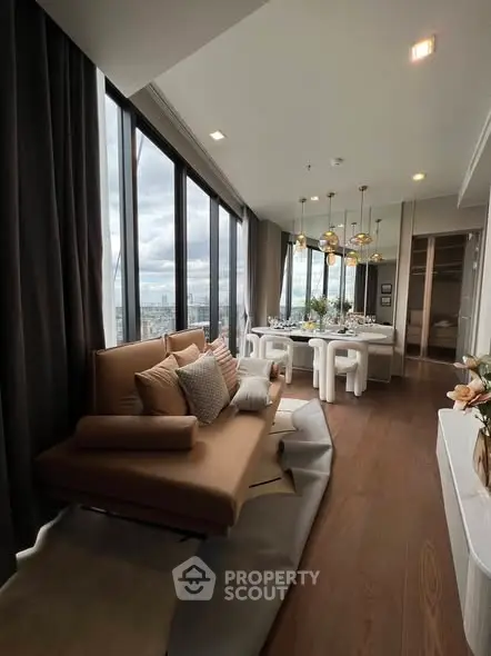 Luxurious modern living room with panoramic city views and elegant decor.