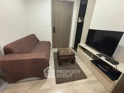 Cozy living room with modern TV setup and comfortable seating
