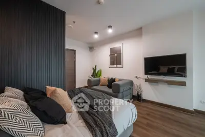 Modern living room with cozy sofa and wall-mounted TV in stylish apartment