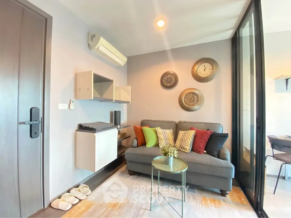 Cozy living room with modern decor and comfortable seating in a stylish apartment.