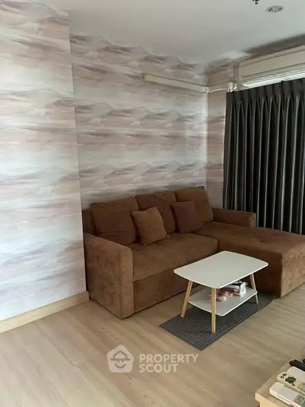 Cozy living room with stylish brown sofa and modern coffee table, perfect for relaxation.