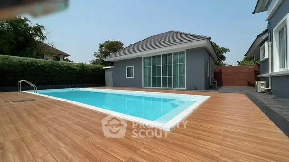 Modern home with sleek pool and spacious deck, perfect for luxury living.