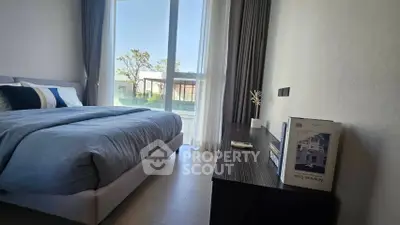 Modern bedroom with large window and stylish decor