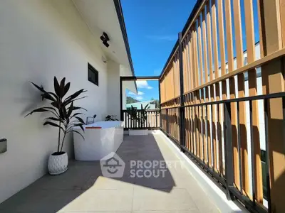 Spacious balcony with modern design and scenic view, perfect for relaxation.