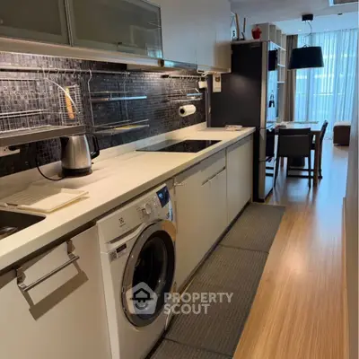 Modern kitchen with sleek appliances and open layout in stylish apartment