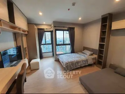 Modern bedroom with city view, featuring stylish furniture and ample natural light.