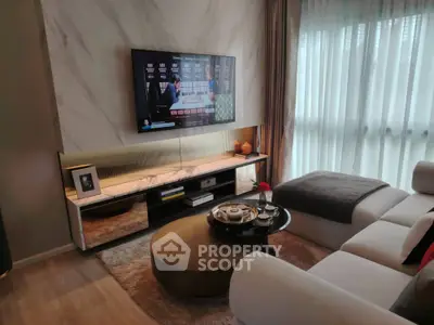 Modern living room with stylish decor and wall-mounted TV
