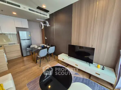 Modern living room with dining area, sleek furniture, and stylish lighting in a contemporary apartment.