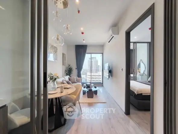 Modern apartment interior with open living and dining area, featuring city view.