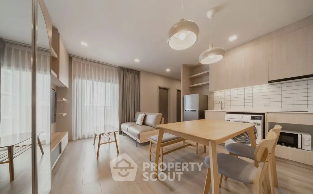Modern open-plan living room with dining area and kitchen in stylish apartment