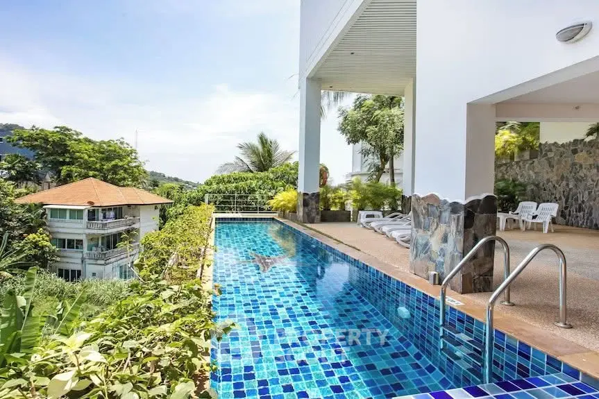 Luxurious poolside view with lush greenery and modern architecture, perfect for relaxation and leisure.
