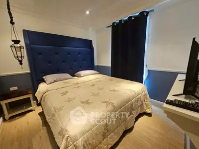 Cozy bedroom with elegant blue headboard and modern decor