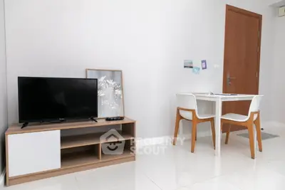 Modern minimalist living room with TV stand and dining table in bright apartment.