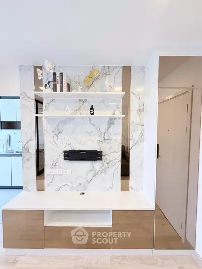 Modern living room with elegant marble wall and built-in shelving
