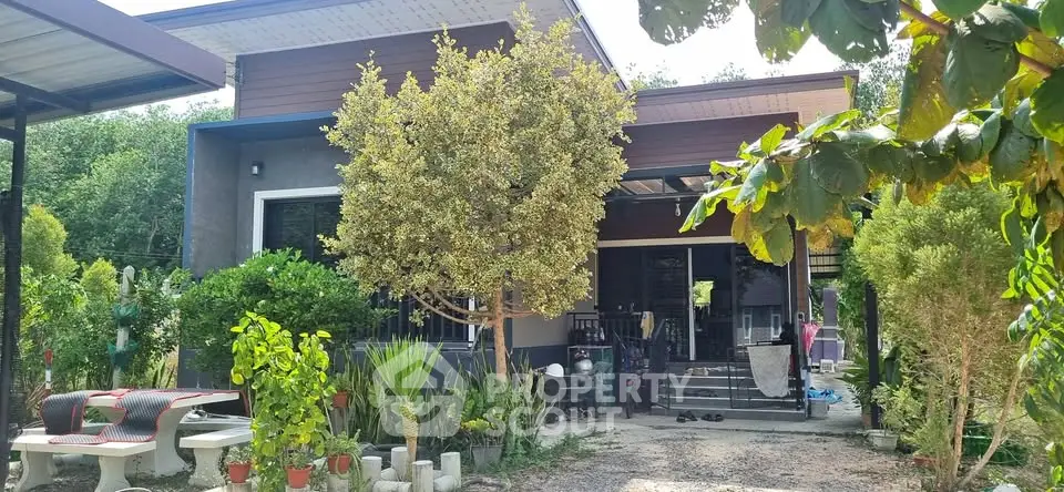 Charming modern house with lush garden and inviting entrance, perfect for serene living.