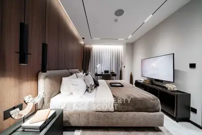 Luxurious modern bedroom with elegant decor and ambient lighting, featuring a large bed and stylish furnishings.