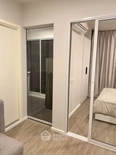 Modern bedroom with mirrored closet and air conditioning