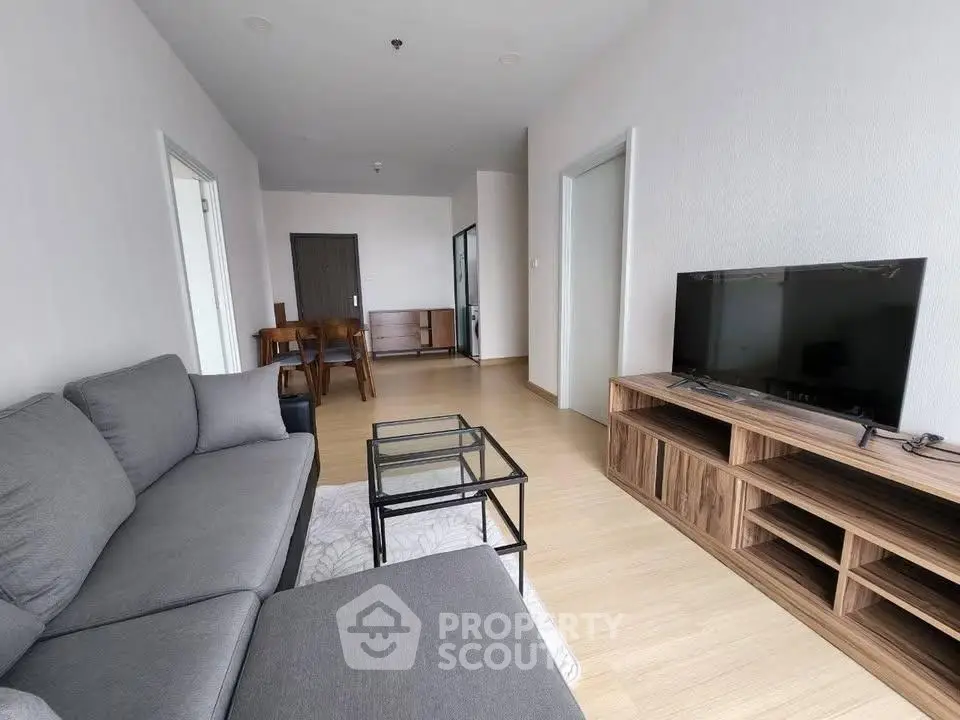Spacious modern living room with sleek furniture and wooden flooring
