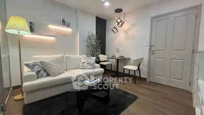 Modern living room with cozy sofa, stylish lighting, and elegant decor