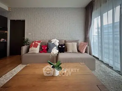 Stylish living room with cozy sofa and large windows offering natural light.