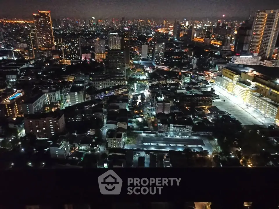 Stunning cityscape night view from high-rise building showcasing vibrant urban lights.