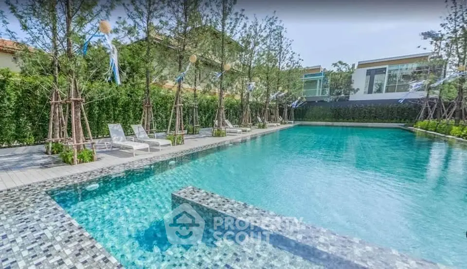Luxurious residential pool area with modern design and lush greenery, perfect for relaxation and leisure.