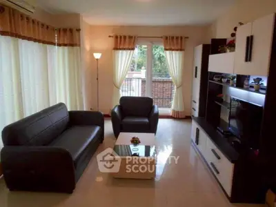 Spacious living room with modern furniture and large windows for natural light.