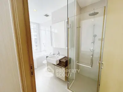 Luxurious bathroom with glass shower and modern fixtures in high-rise apartment