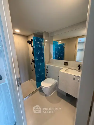 Modern bathroom with sleek shower and stylish fixtures in a contemporary apartment.