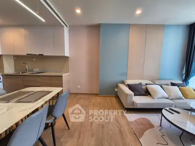 Modern open-plan living room with stylish kitchen and cozy seating area.