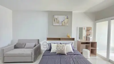 Modern bedroom with stylish decor and natural light