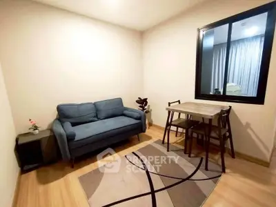 Cozy living room with modern sofa and dining table, perfect for urban living.