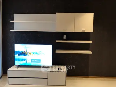 Modern living room with sleek TV unit and wall-mounted cabinets