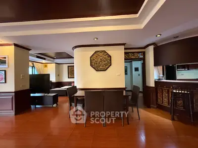 Spacious living room with elegant wooden decor and dining area in a luxurious apartment.