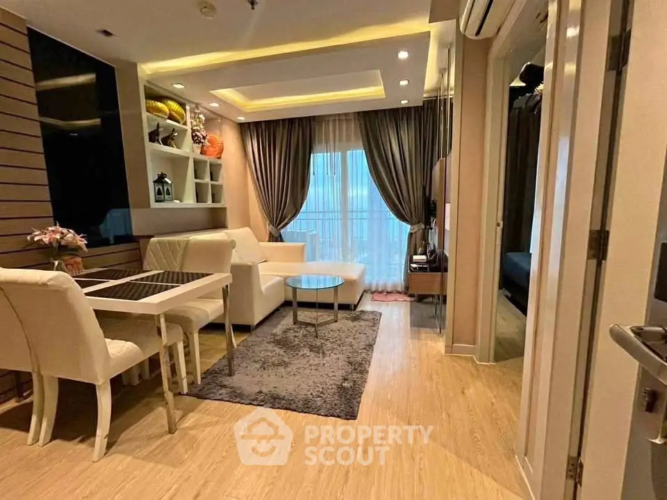 Modern living room with elegant dining area and cozy seating, featuring stylish decor and natural light.